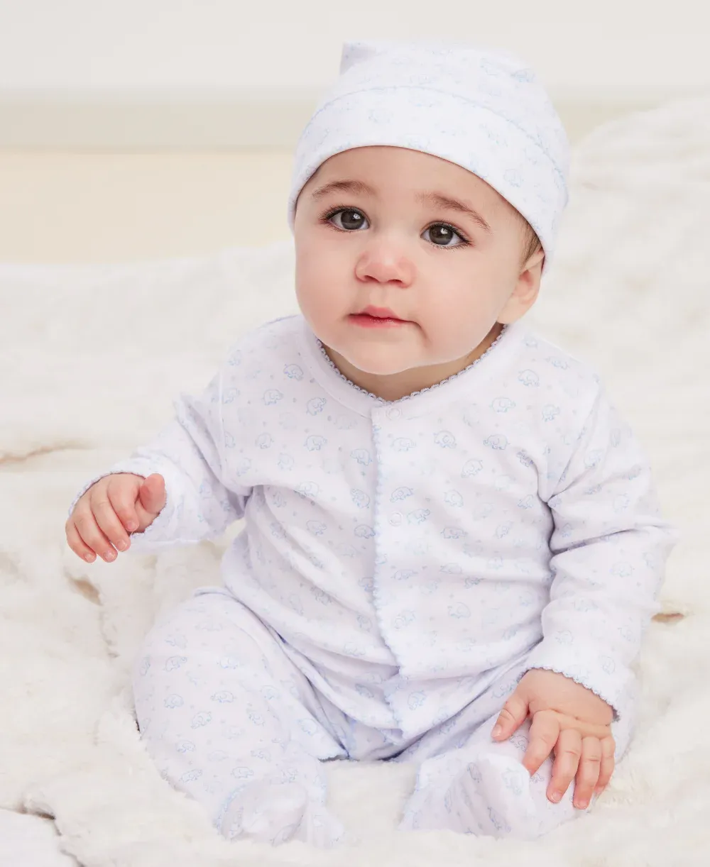 Baby wearing pink floral pajamas or outfit sitting on a neutral background. Cute children's sleepwear design.