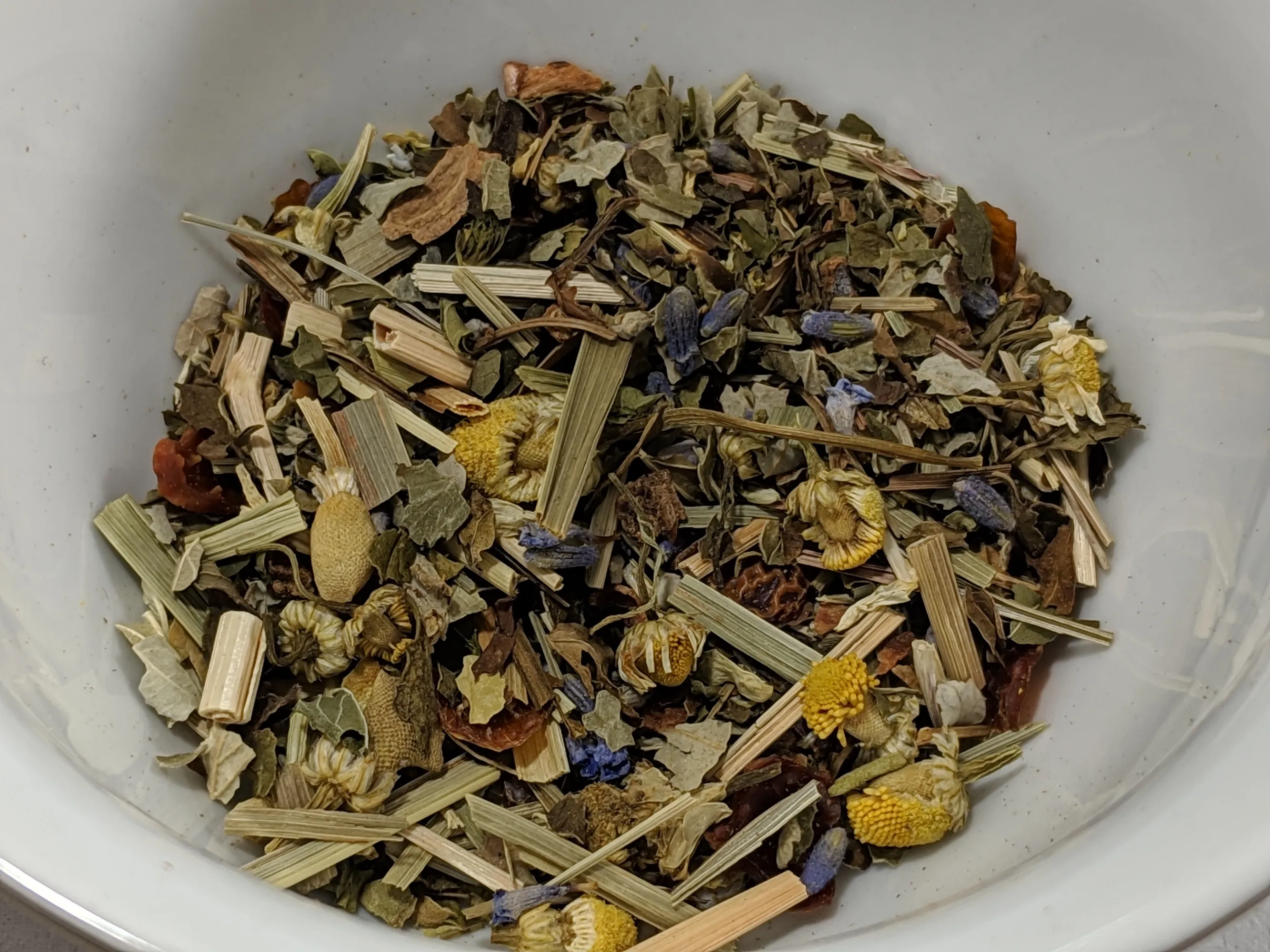 Various premium tea products displayed elegantly with tea leaves. Colorful selection of tea packages and loose tea. No human shapes.