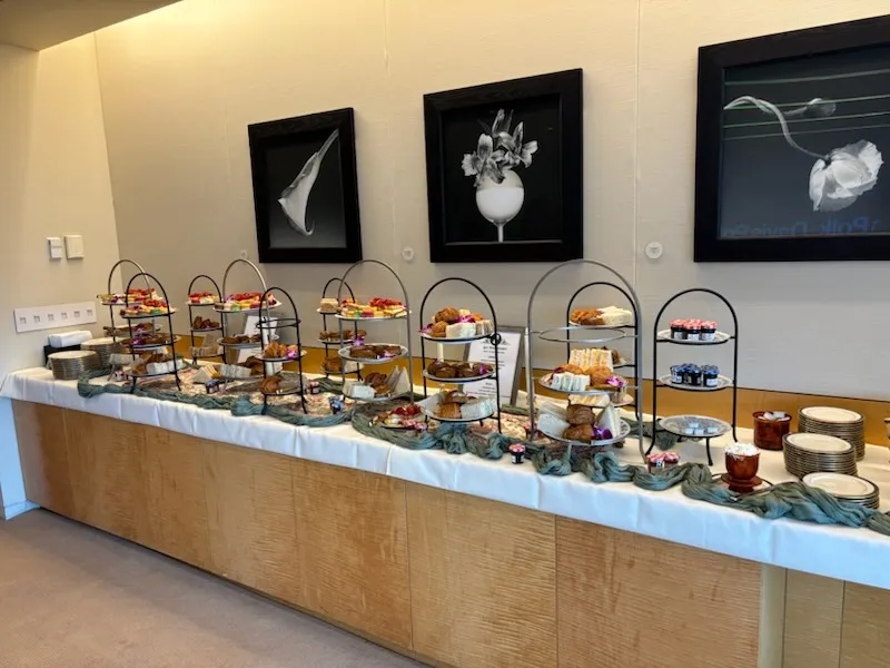 Tea tasting event setup with multiple tea stations, tasting notes, and elegant decor. Welcoming atmosphere for tea enthusiasts. No human shapes.
