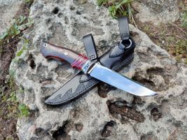 mammoth tooth blood red spacer on knifehand