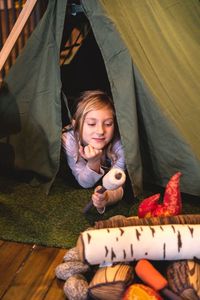 Girl in tent in kids play area