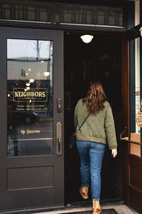 Woman entering Neighbors Mercantile
