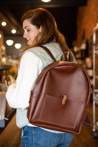 Woman with leather backpack