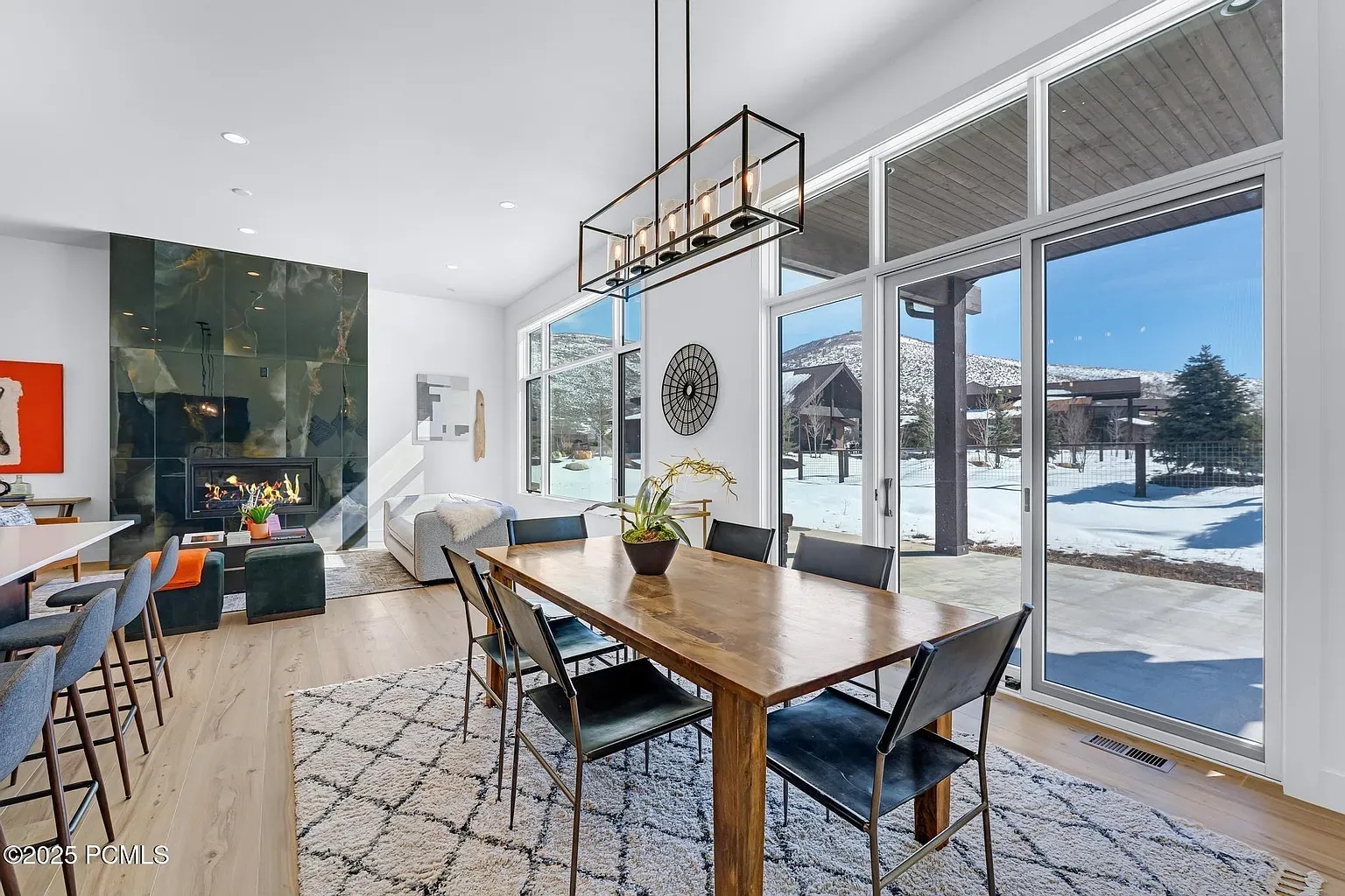 Home staging service with modern living room featuring a sleek fireplace, marble surfaces, and elegant furniture. No human shapes.