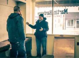 Denny Martin, the former owner of Martin Hardware, giving a tour to Marcus, the new owner of the building.