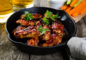 Cooked chicken in cast iron skillet.