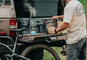 Man cooking a Peak meal on pickup tailgate.
