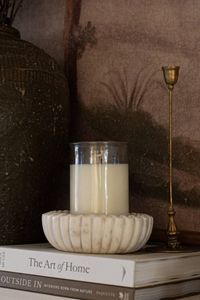 White candle in clear glass jar