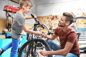 Father and son working on bicyc