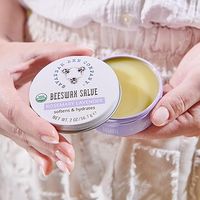 Woman holding Savanah Bee Company Beeswax Salve