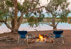 GCI camp chairs around outdoor fire.