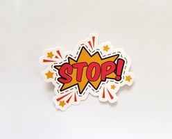 Sticker with the word "Stop" in red text over a yellow comic styled explosion and stars.