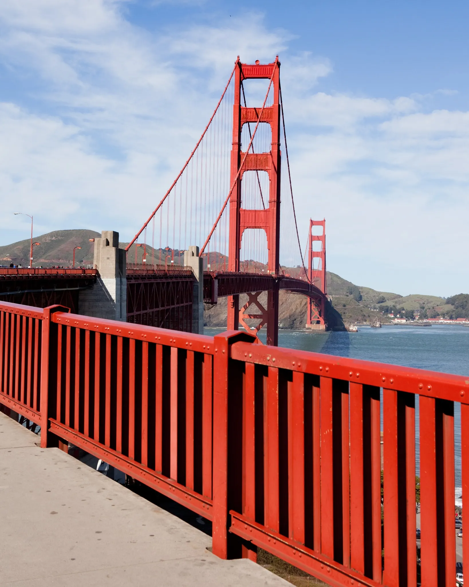 Original pedestrian handrail in the foreground with the Golden Gate Bridge towers beyond