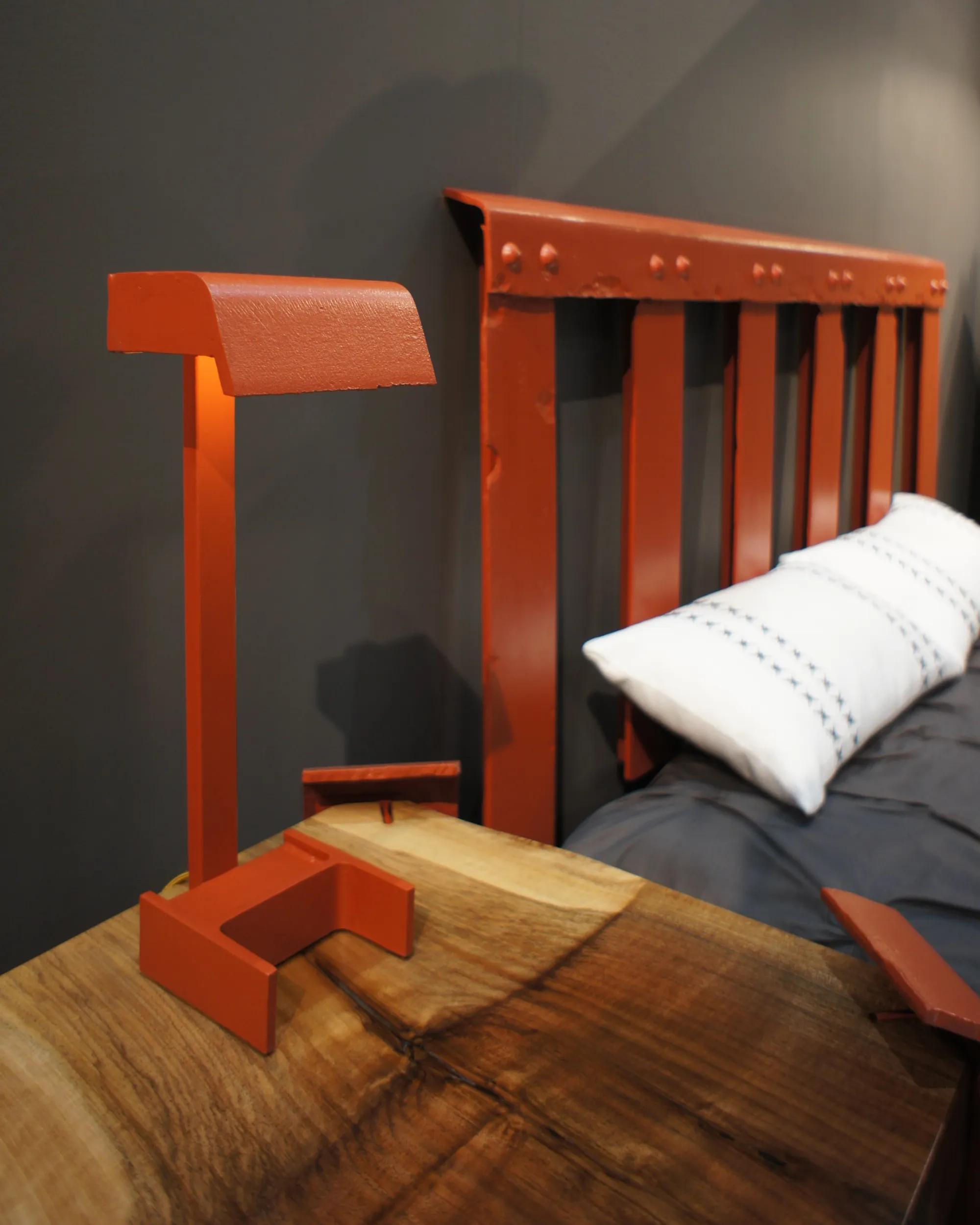 Headboard and bedside lamp made from original Golden Gate Bridge handrail steel