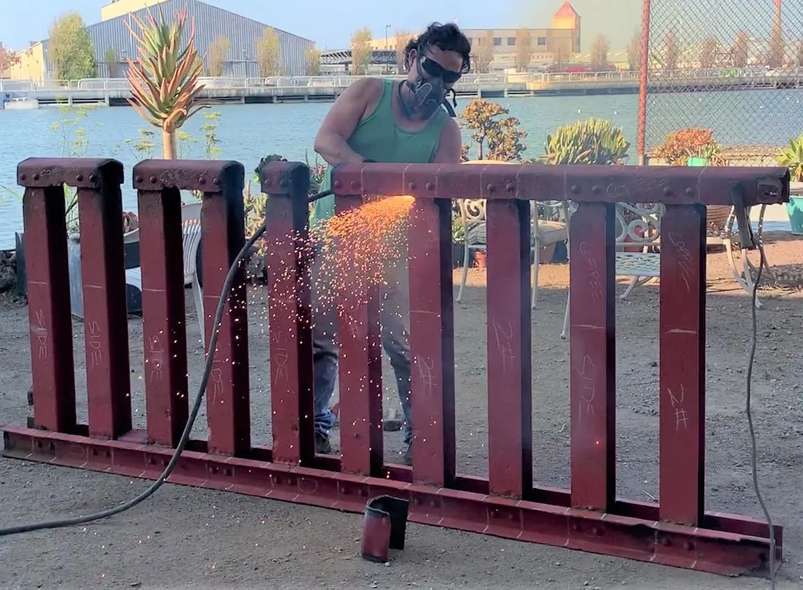Working on a section of bridge handrail.