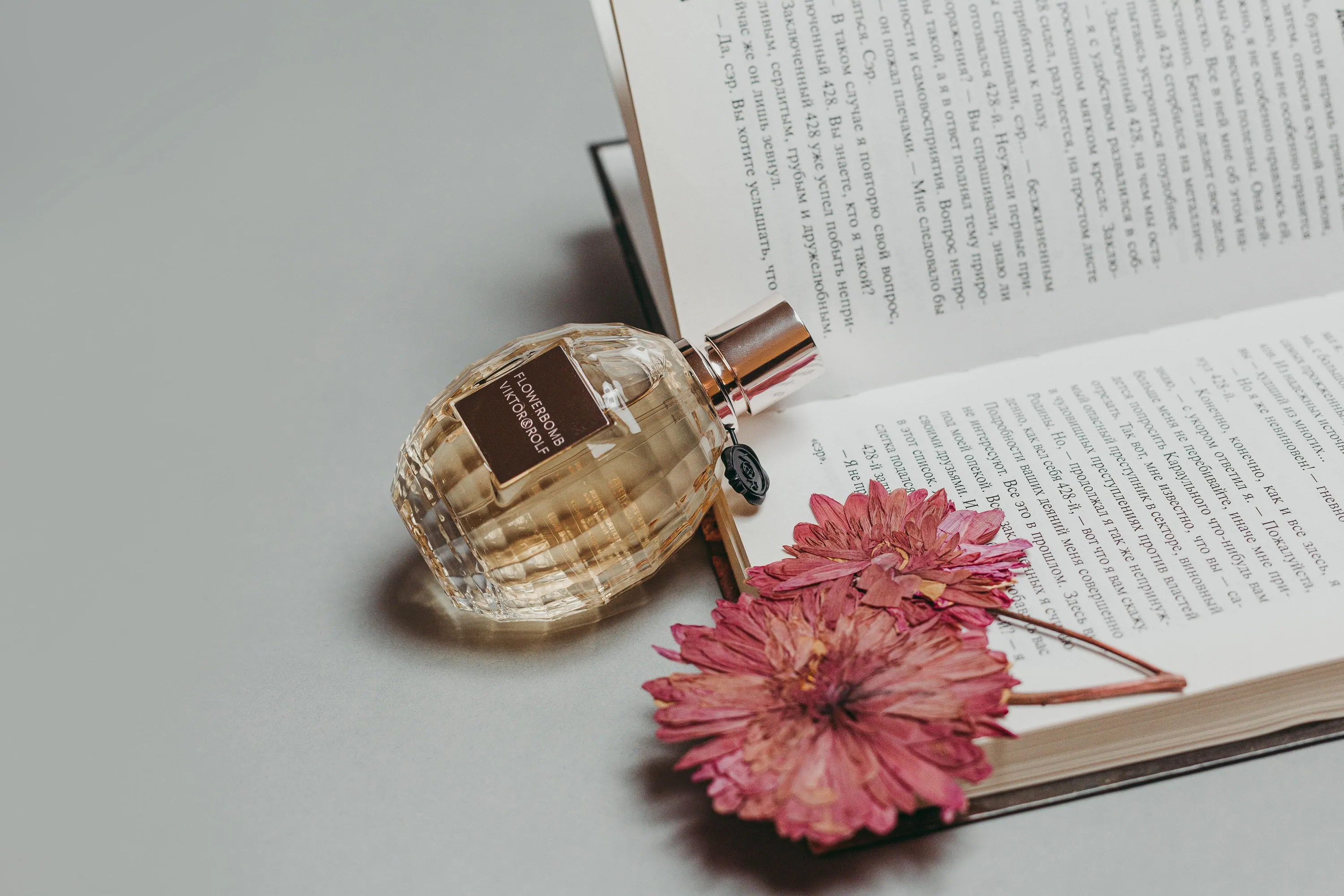 A fragrance beside flowers and a book