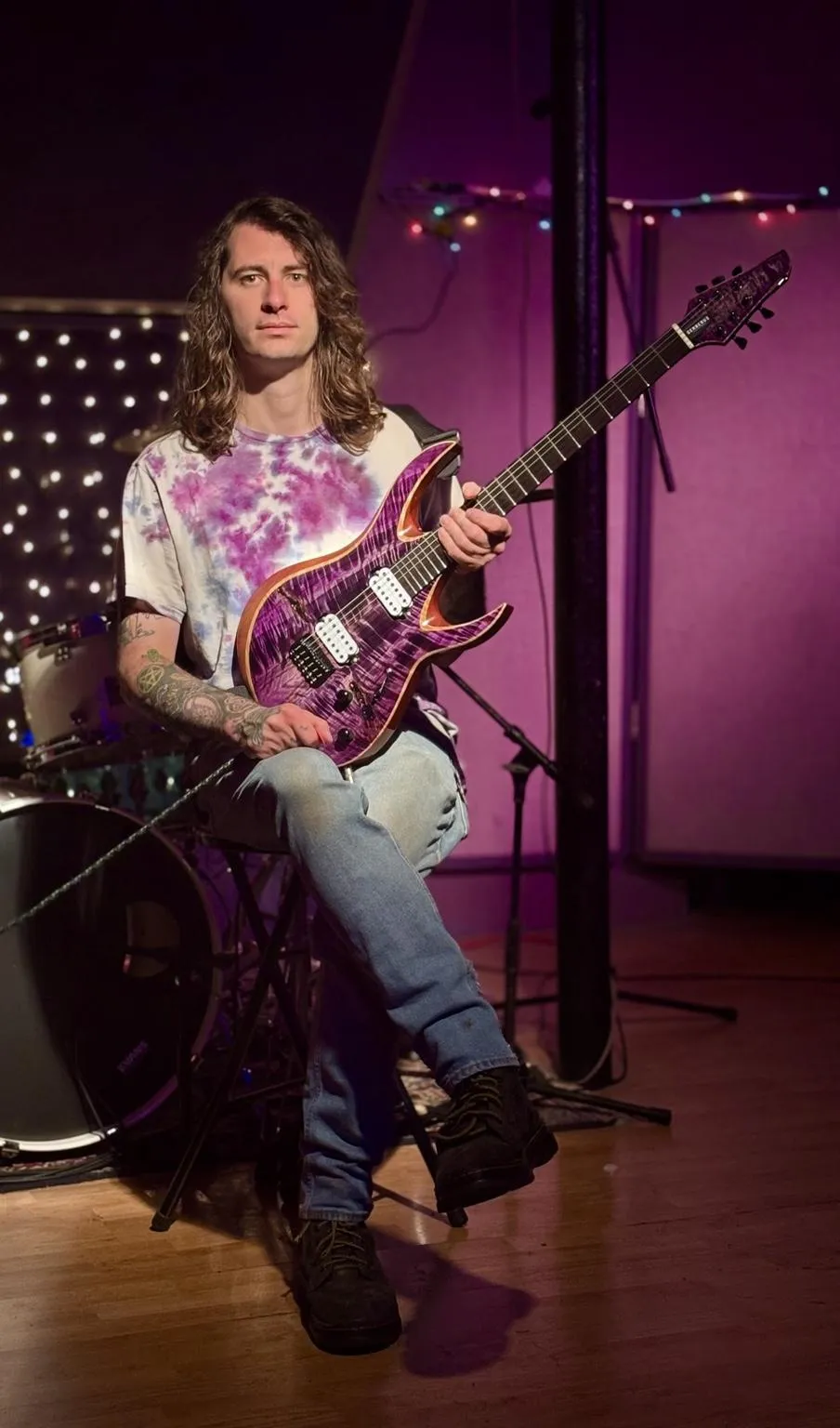 Taylor Budahazy at Speak Easy Studios holding his USA-made Cerberus Chimera guitar.