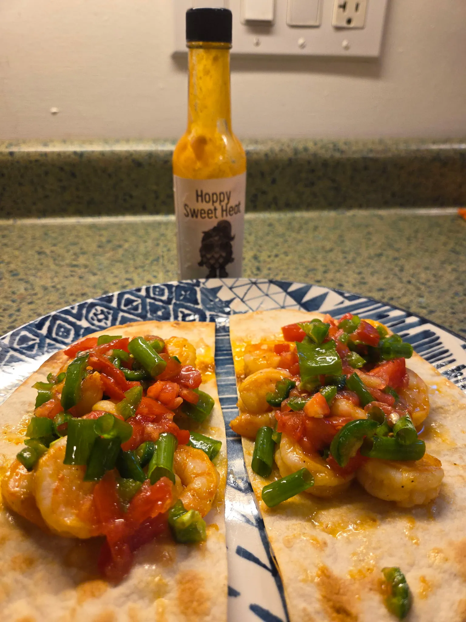 Folded tacos filled with shrimp being placed in a toaster oven, ready to be crisped. Tortillas contain shrimp and fresh salsa. Do not generate human shapes.