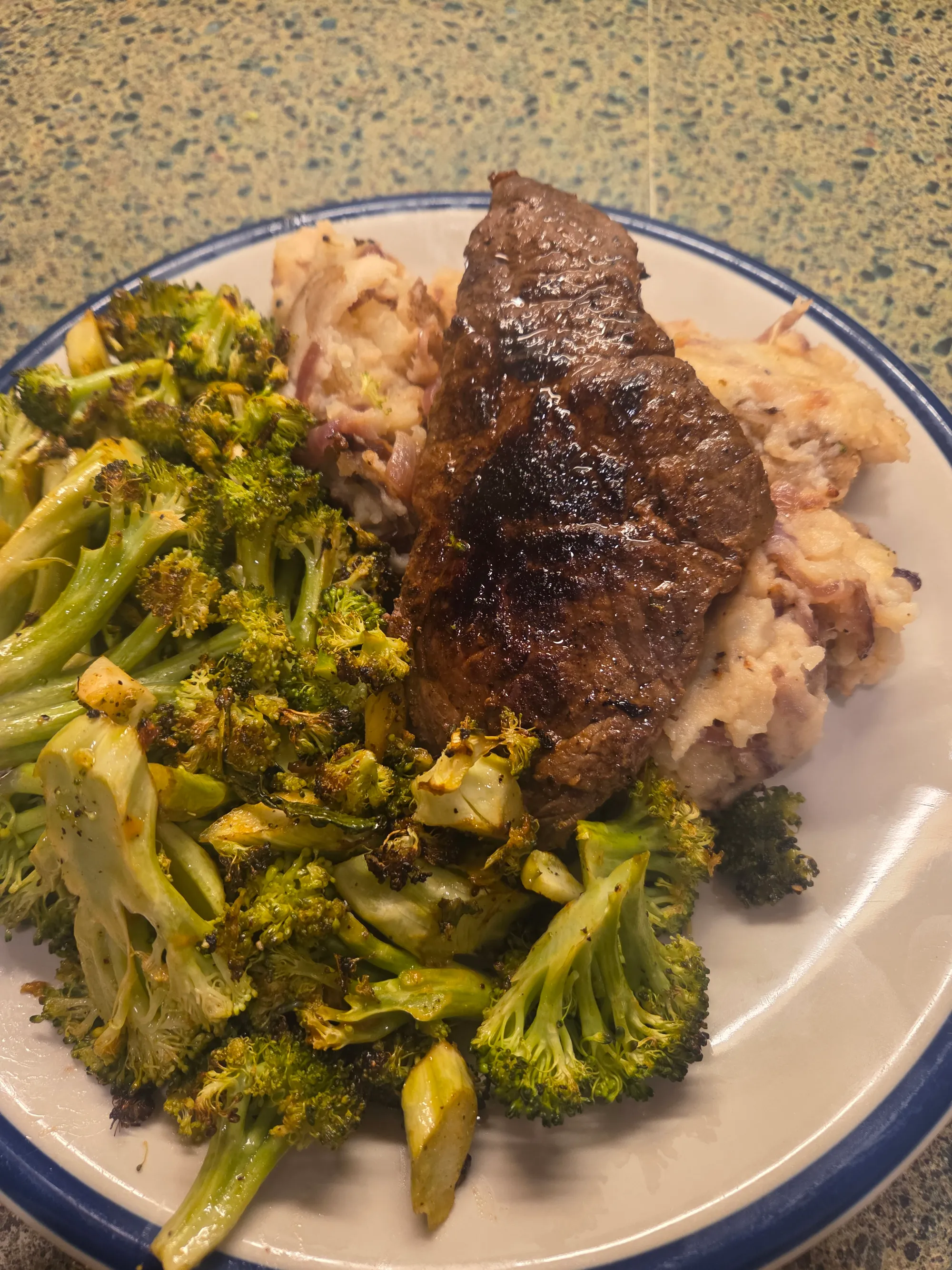 Beautifully plated meal with sliced steak glazed with Mustard BBQ sauce, broccoli with Sweet Heat, and creamy caramelized onion mash. No human shapes.