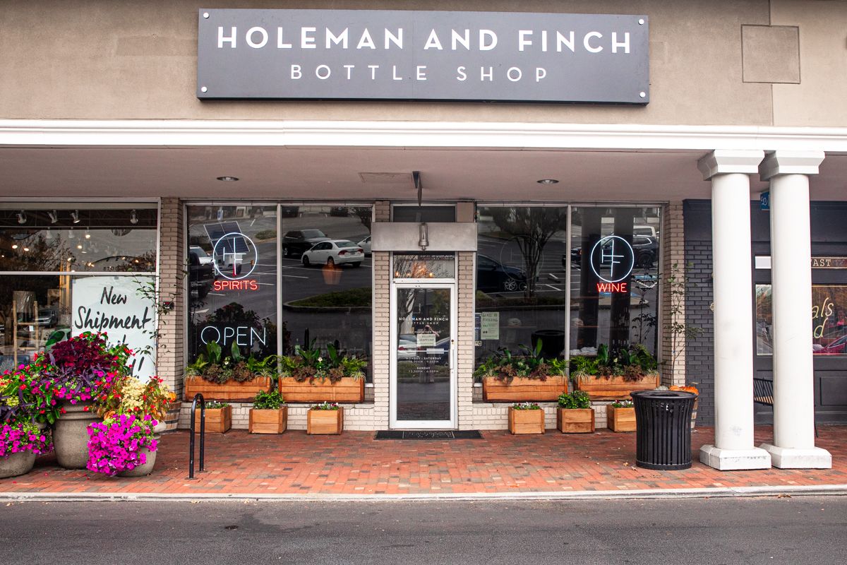Warm, shelf-lined interior of Holeman & Finch Bottle Shop